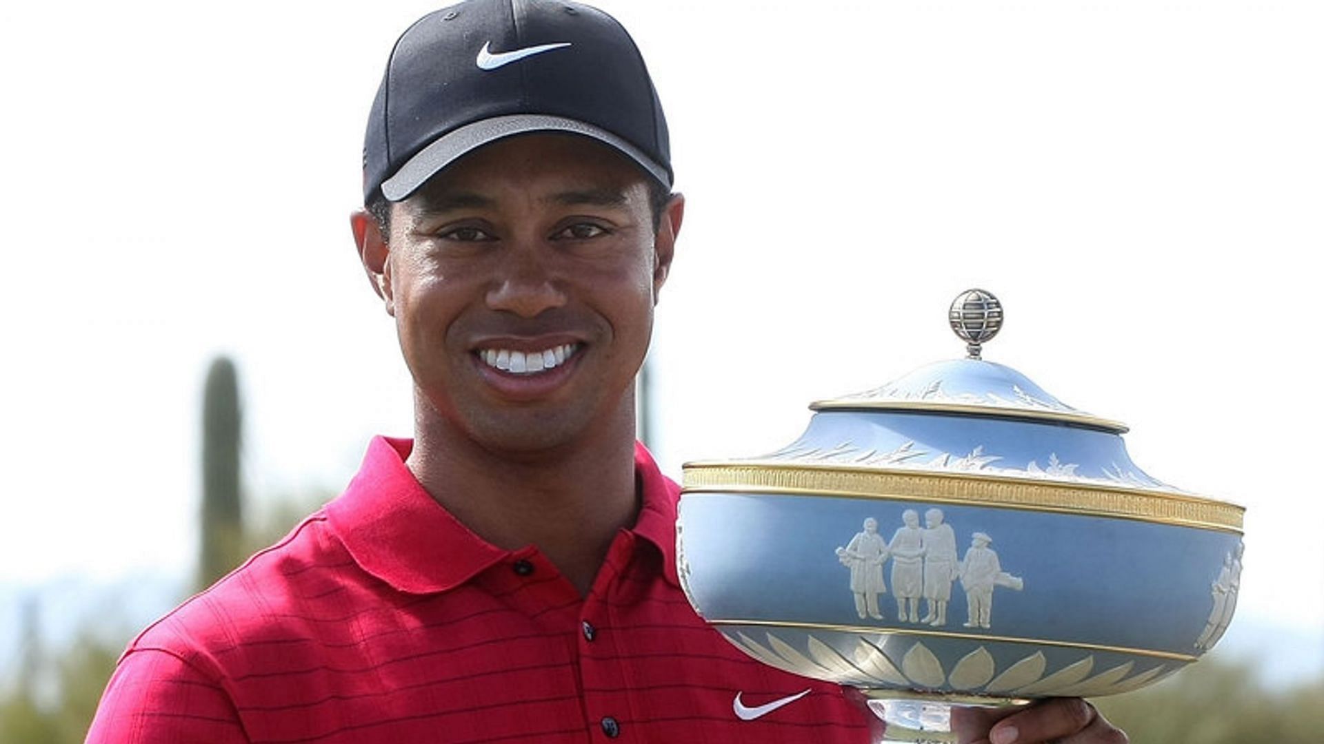 Tiger Woods posing with WGC Match Play 2008 trophy