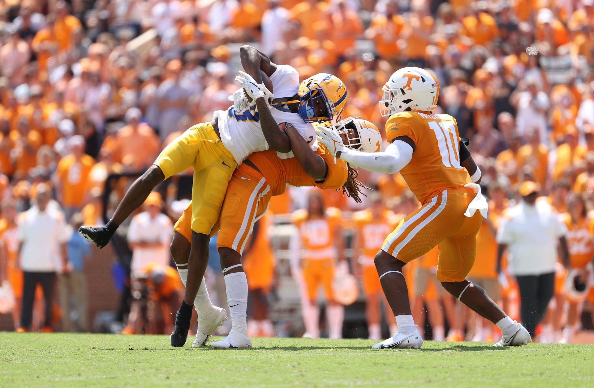 Jordan Addison #3 of the Pittsburg Panthers is tackled by Jeremy Banks #33 of the Tennessee Volunteers