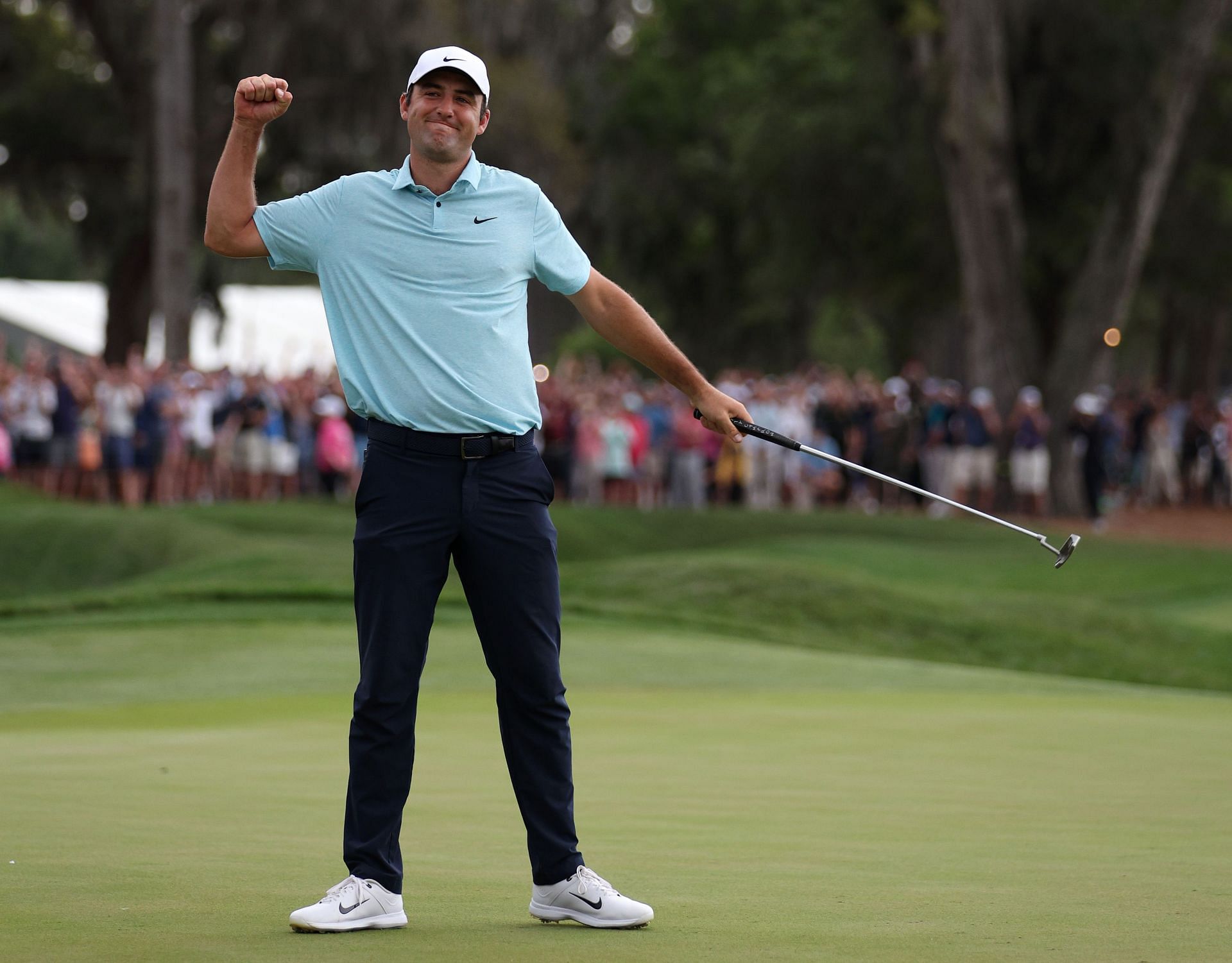 On March 12, 2023, in Ponte Vedra Beach, Florida, Scottie Scheffler celebrates after sinking his winning putt on the 18th green of THE PLAYERS Championship's final round at TPC Sawgrass.