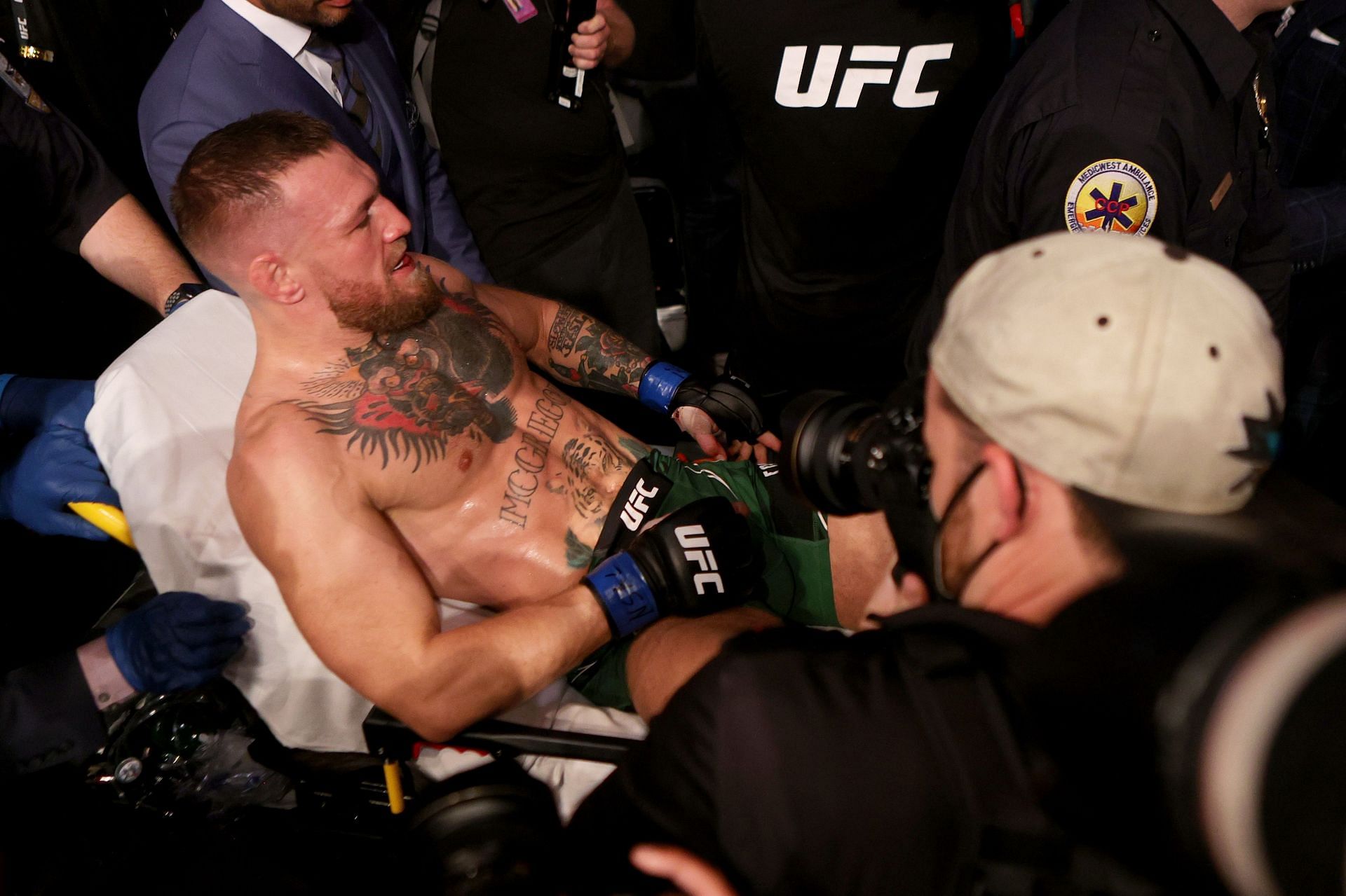 McGregor carried out on a stretcher after breaking his leg at UFC 264 [Image courtesy: Getty Images]