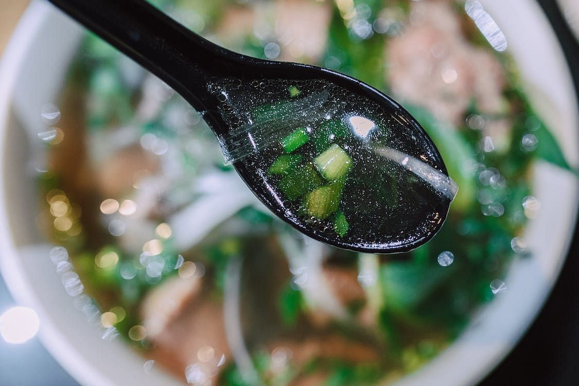 It is often served with fresh herbs and bean sprouts.(Image via Pexels/Rodnae Productions)
