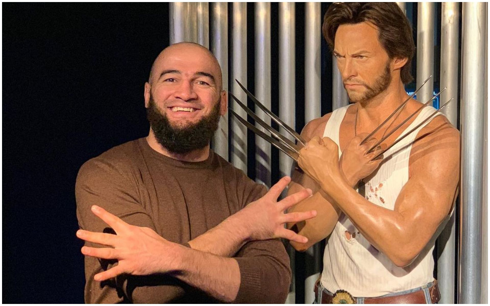 UFC middleweight contender Albert Duraev standing besides Wolverine mannequin