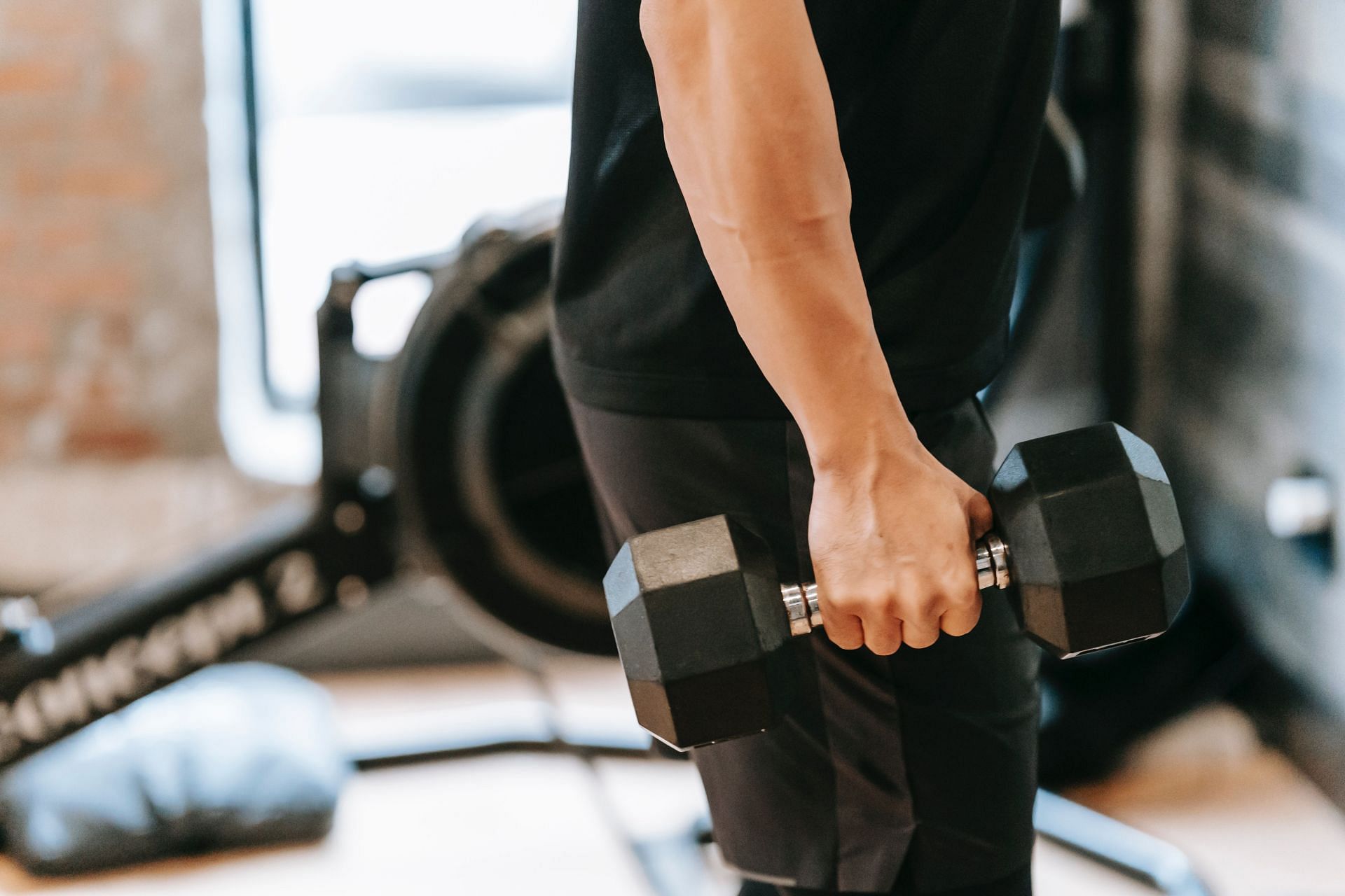 Don&#039;t try to lift too much weight too quickly while working out. (Image via Pexels/Andres Ayrton)