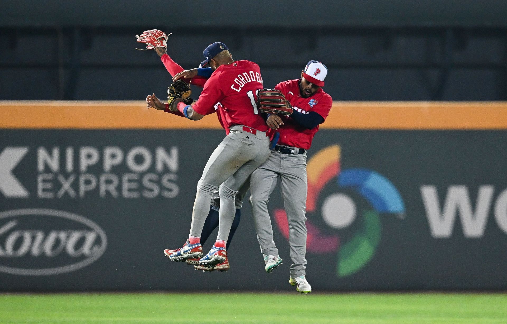 Allen C&oacute;rdoba, Jose Ramos, and Jhonny Santos celebrate after wining during the WBC Pool A game between Panama and Chinese Taipei