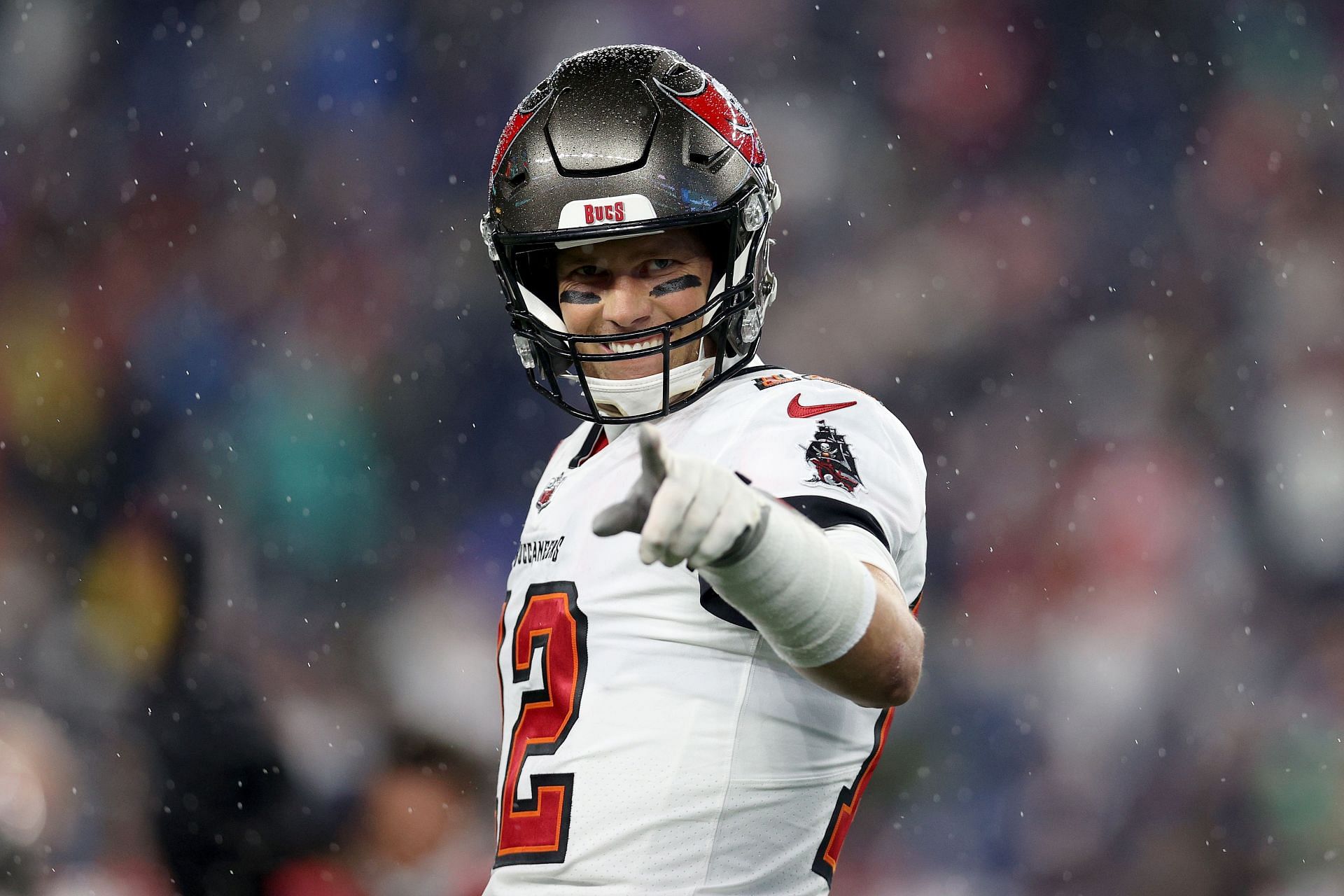 Tom Brady #12 of the Tampa Bay Buccaneers points during warm ups prior to the game against the New England Patriots