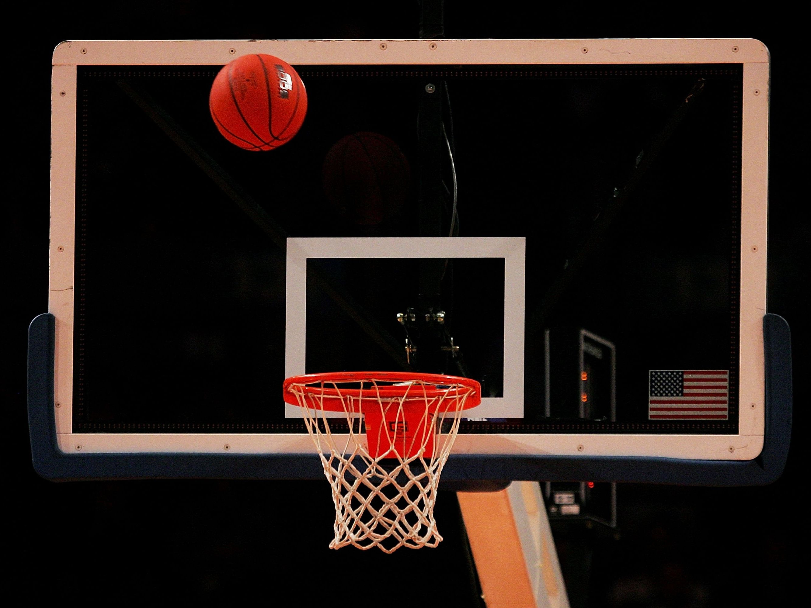 A basketball rim during a game.