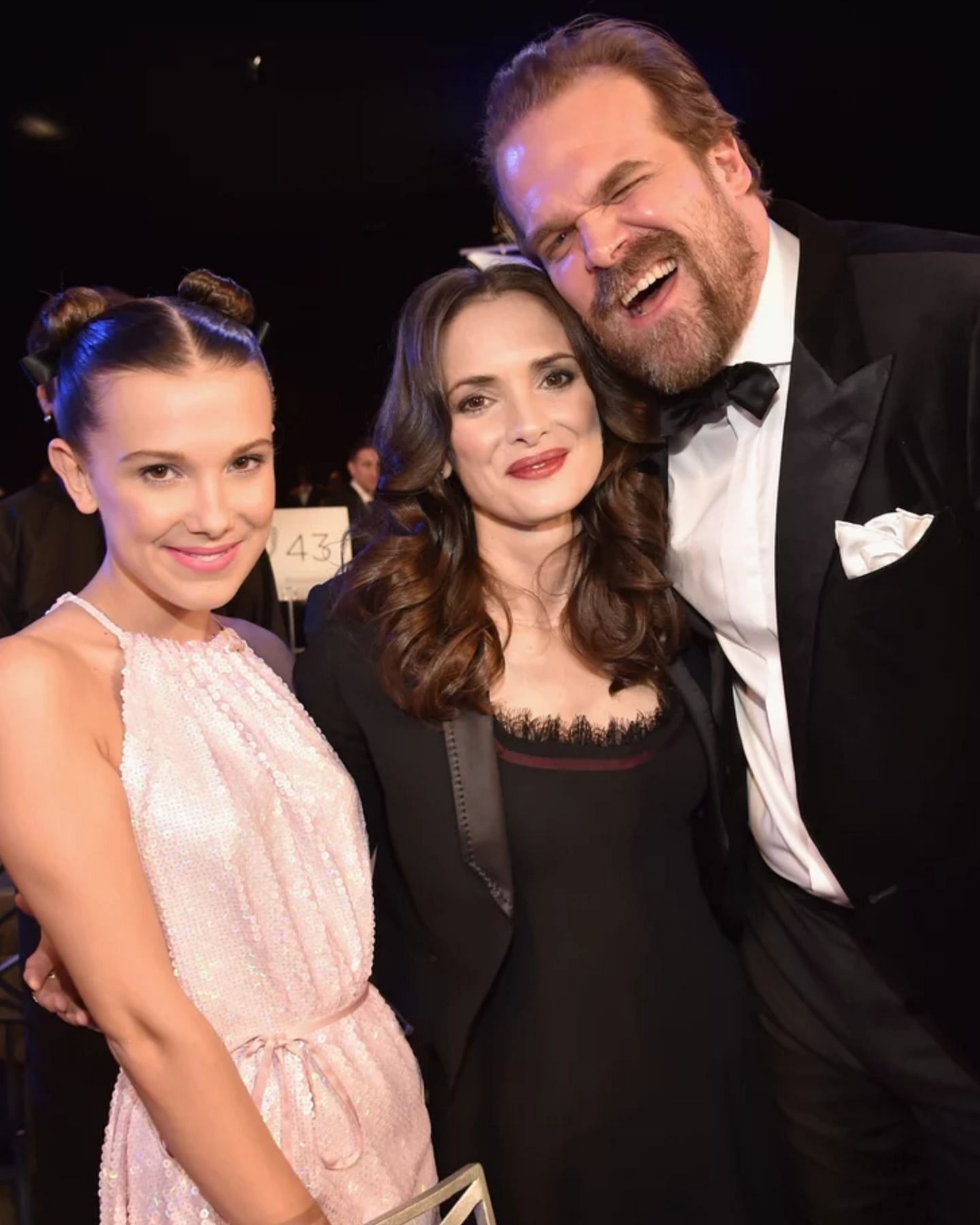 Millie Bobby Brown with Winona Ryder and David Harbour at the 2018 SAG Awards (Image via Getty Images)