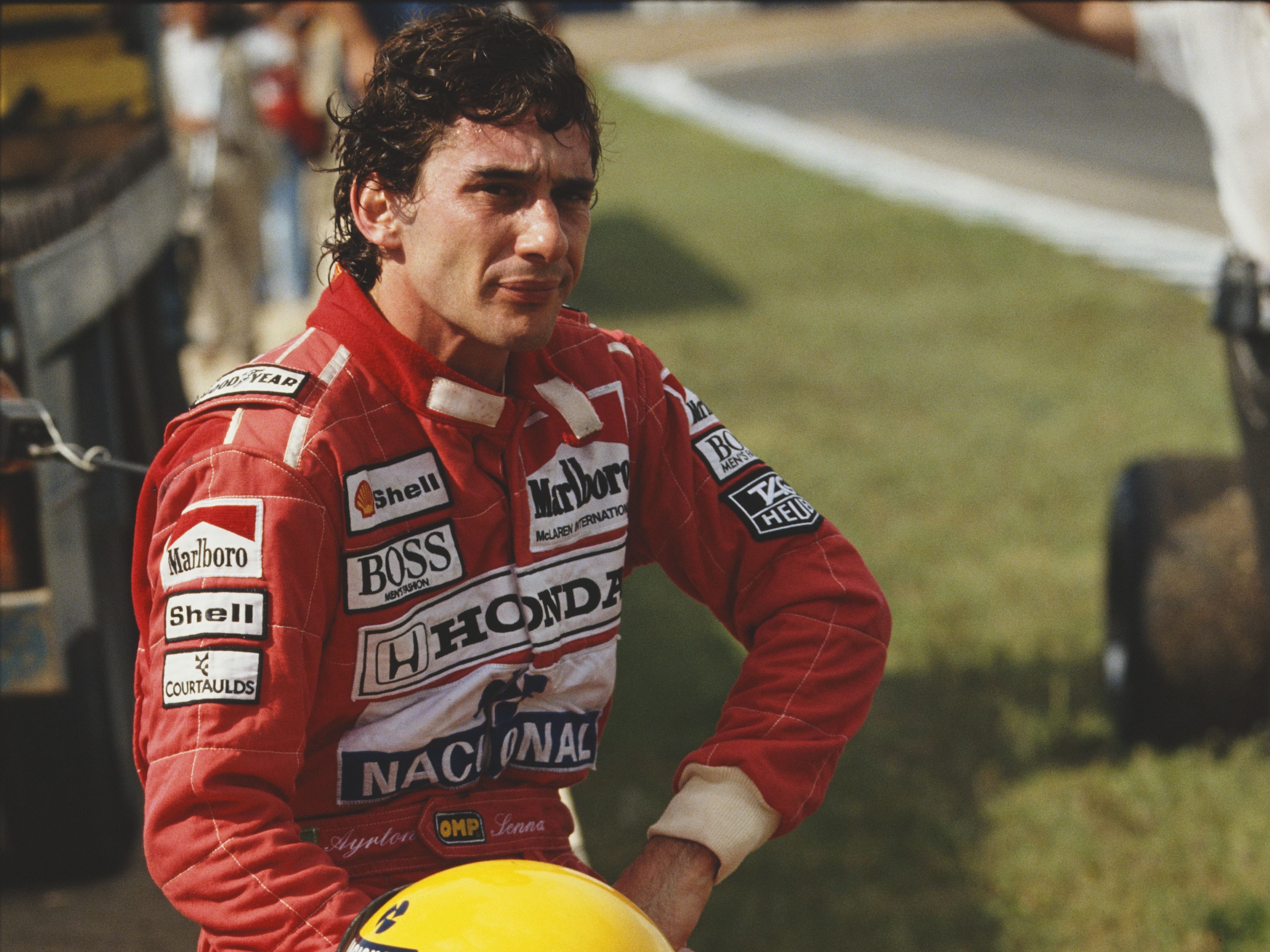 Ayrton Senna sits on a wall after retiring during the 1990 F1 Spanish Grand Prix. (Photo by Pascal Rondeau/Getty Images)