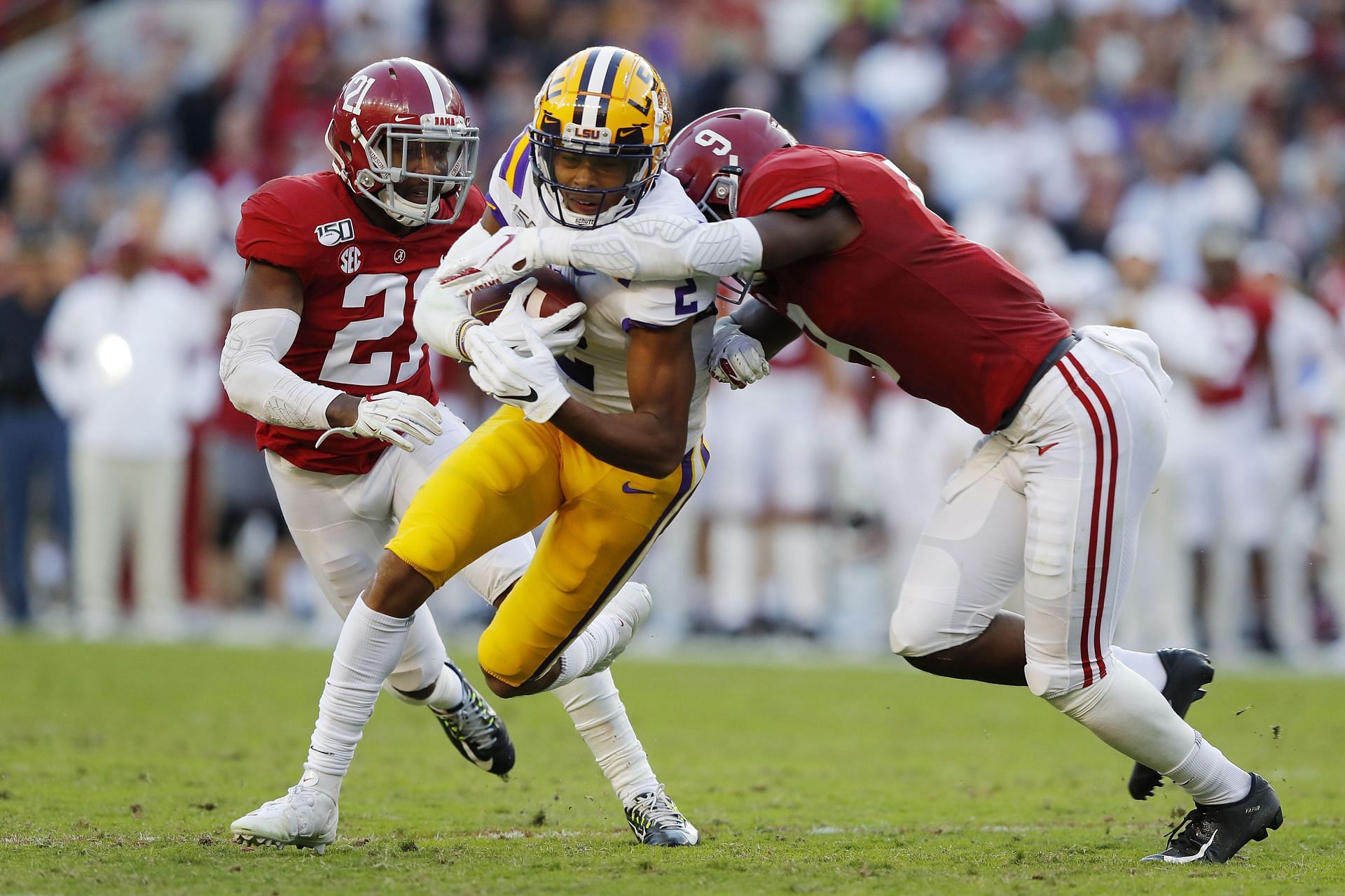  Justin Jefferson #2 of the LSU Tigers is tackled by Jordan Battle #9 of the Alabama Crimson Tide