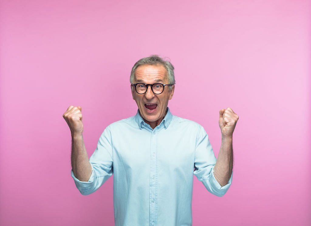 Excited man shouting while gesturing with fists