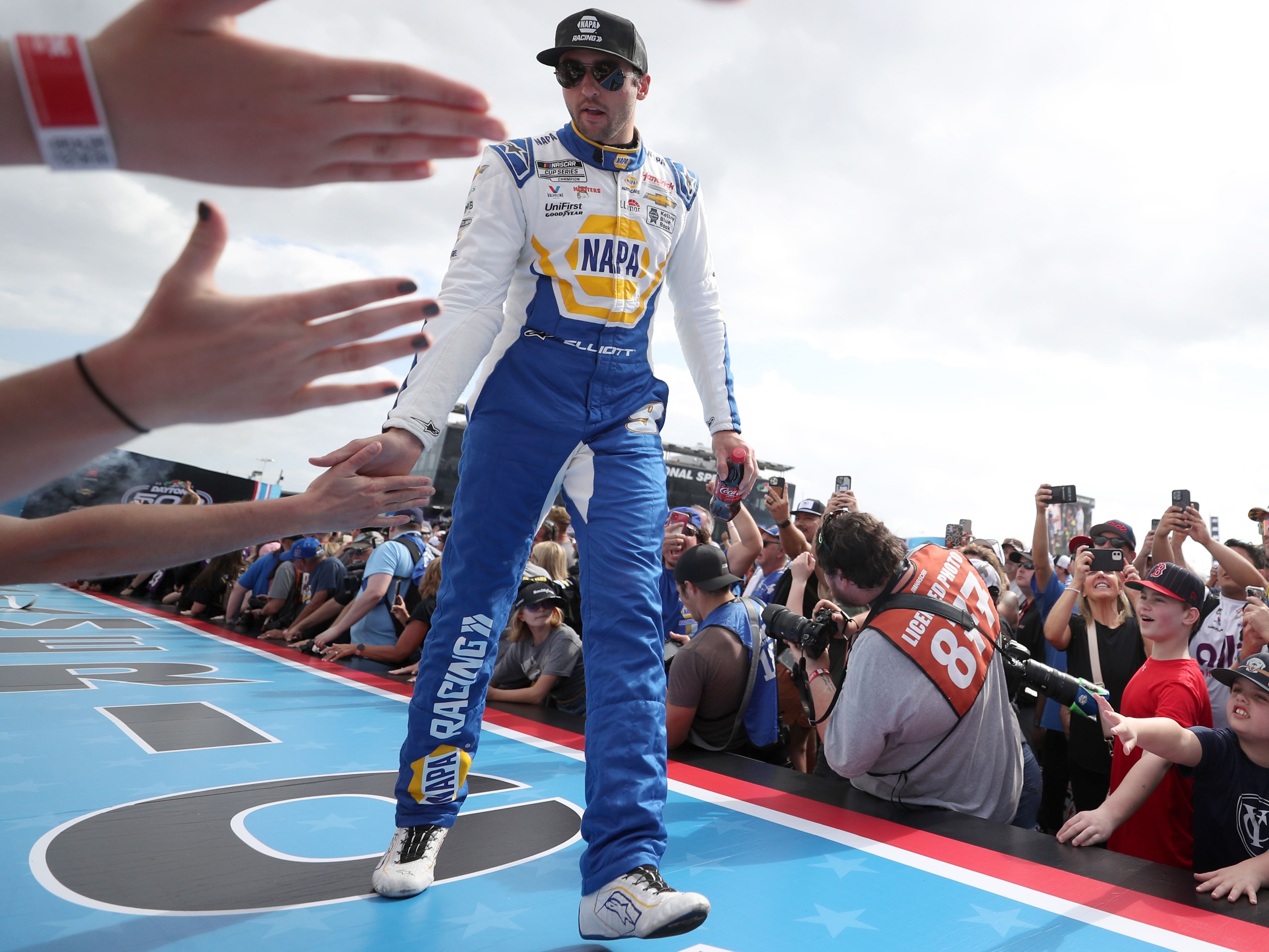 Chase Elliott, driver of the #9 NAPA Auto Parts Chevrolet, greets fans as he walks onstage during driver intros prior to the NASCAR Cup Series 65th Annual Daytona 500 at Daytona International Speedway on February 19, 2023 in Daytona Beach, Florida. (Photo by Courtney Culbreath/Getty Images)