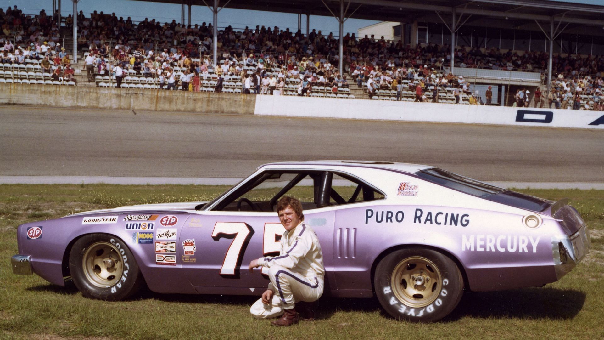 Dick Trickle poses with his #75 Mercury NASCAR at Daytona International Speedway in 1975.