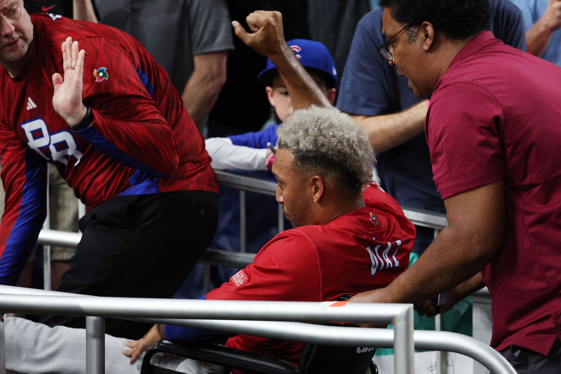 Edwin Diaz of Team Puerto Rico leaves the field in a wheelchair after sustaining an injury.