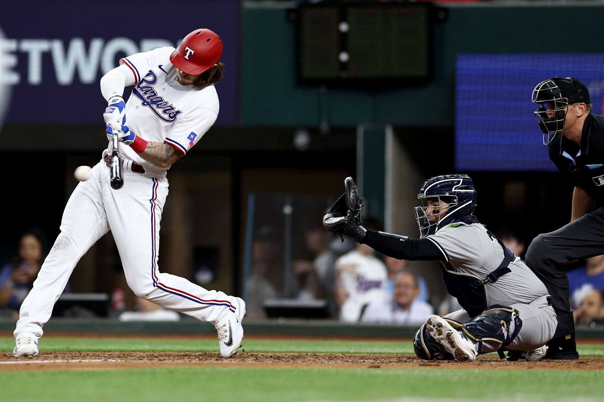 Jonah Heim #28 of the Texas Rangers hits a RBI single against the New York Yankees