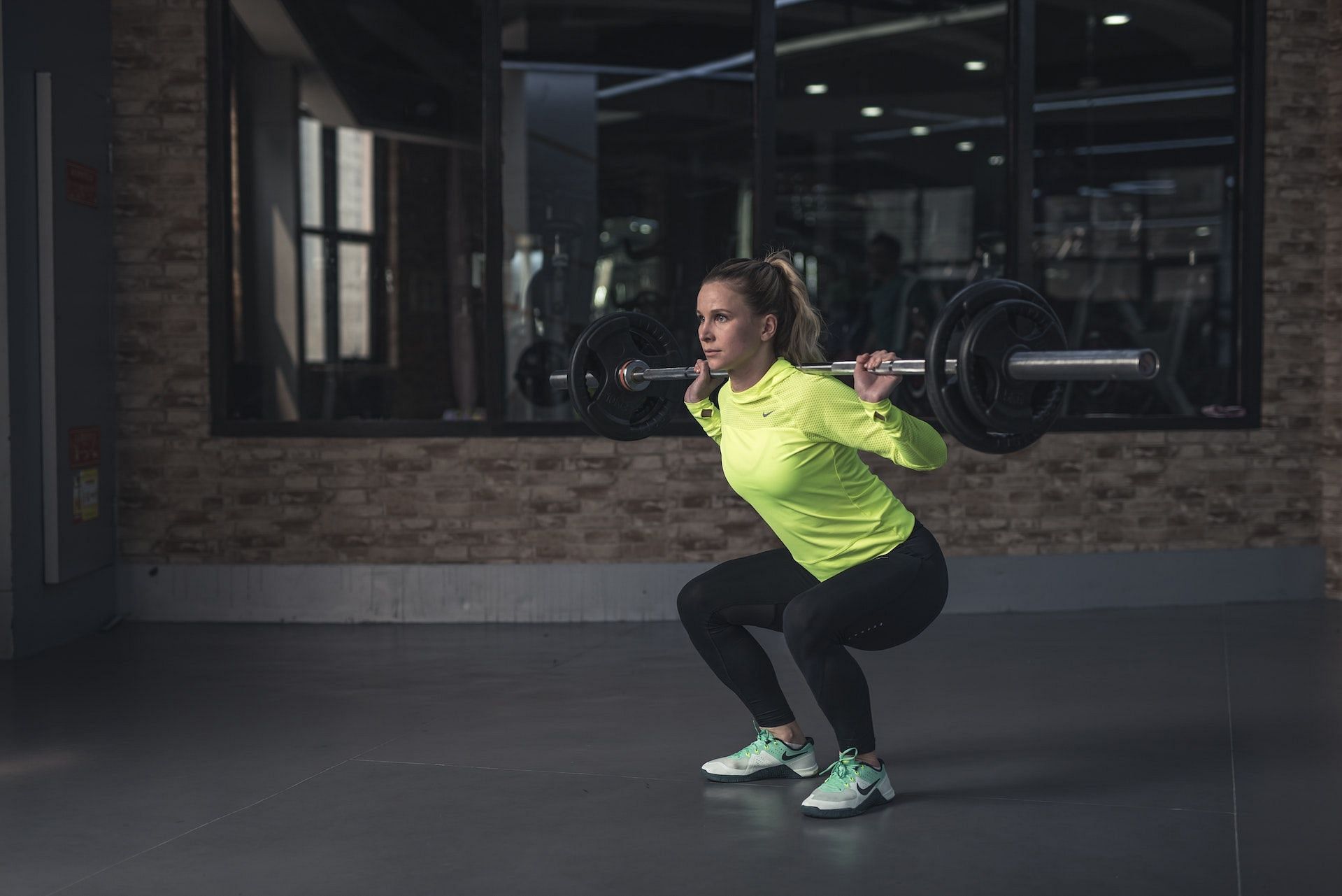 Barbell back squats are one of the best lower glute exercises. (Photo via Pexels/Li Sun)