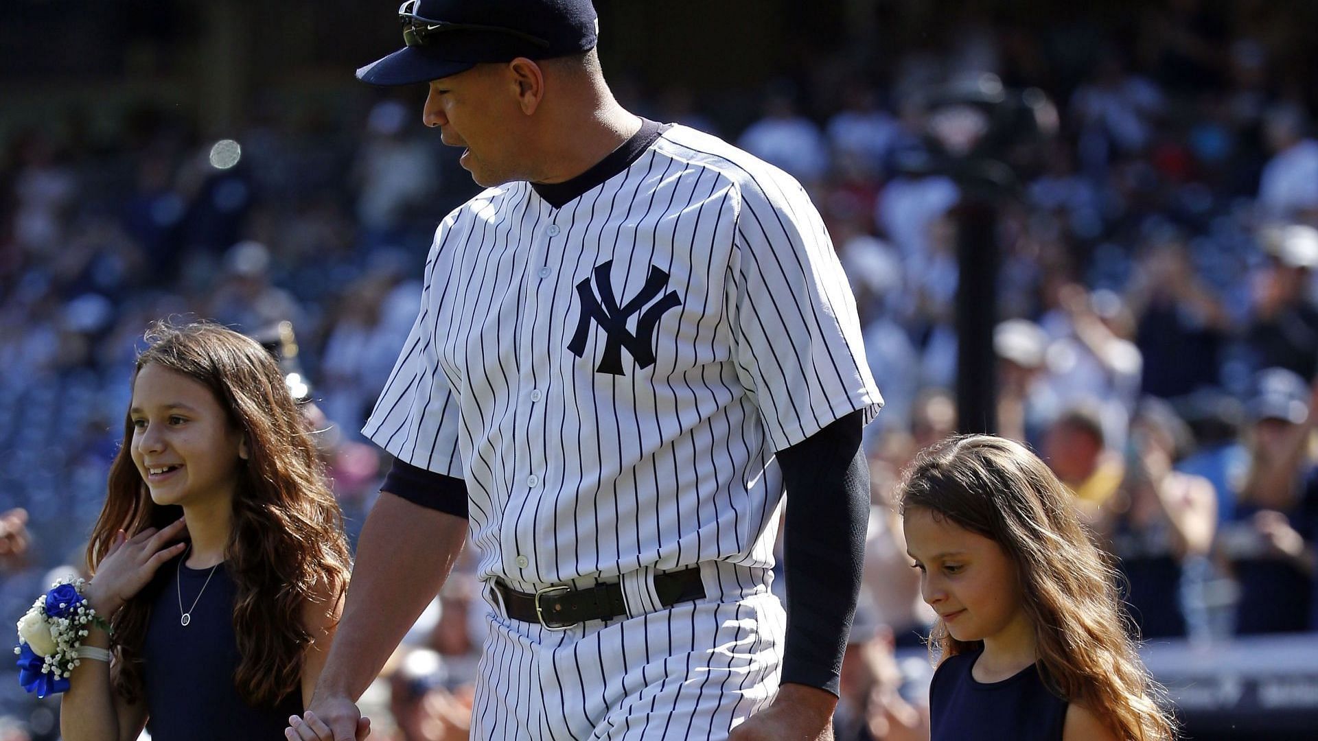 Toronto Blue Jays v New York Yankees. Alex Rodriguez #13 of the New York Yankees and his daughters, Natasha and Ella, walk onto the field for a pregame ceremony celebrating Rodriguez