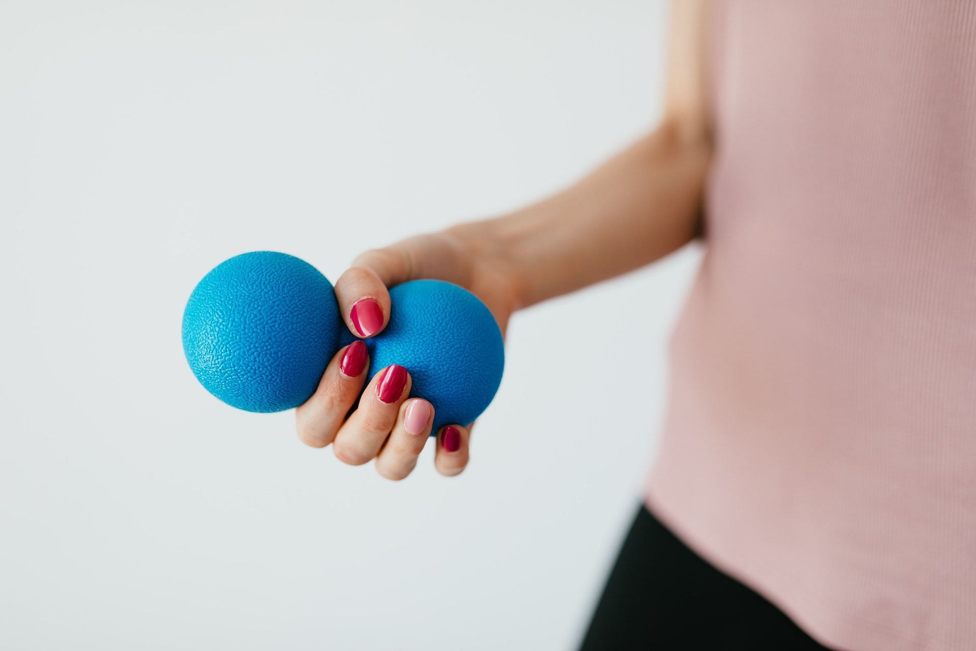 Ball squeeze improves wrist mobility. (Photo via Pexels/Karolina Grabowska)