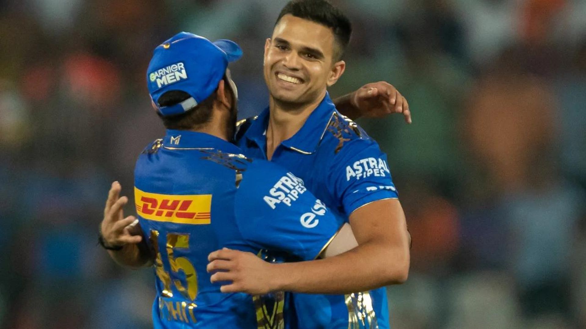 Rohit Sharma hugs Arjun Tendulkar (R) after MI