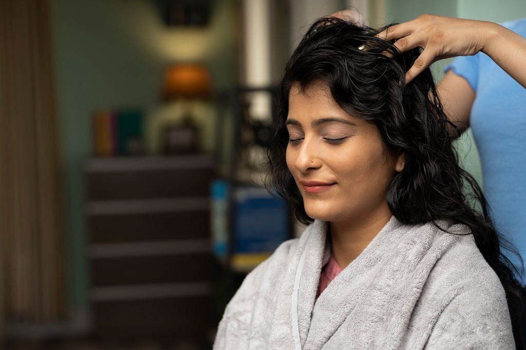 Discovering the health benefits of scalp massage (Image via Getty)