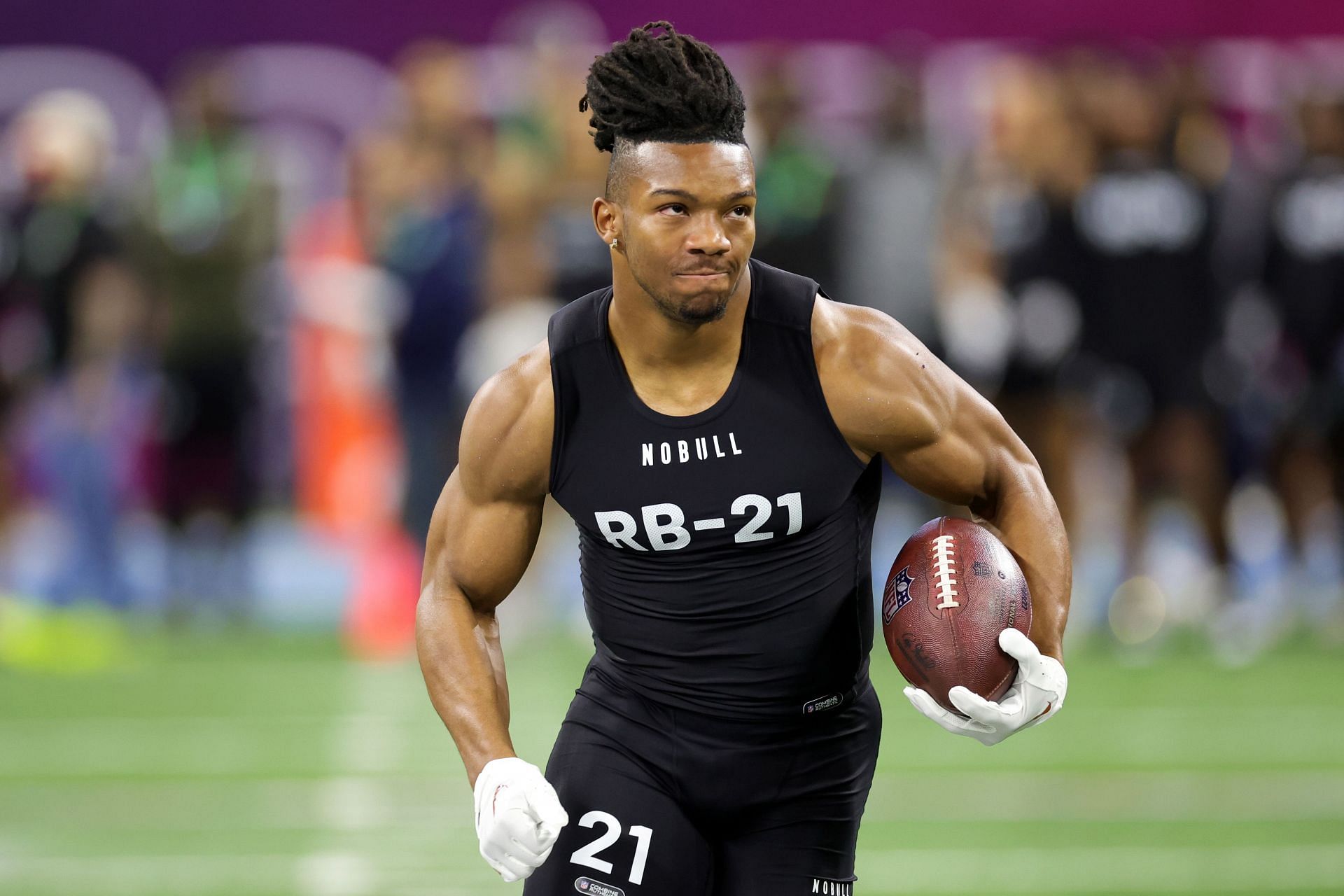 Bijan Robinson of Texas participates in a drill during the NFL Combine