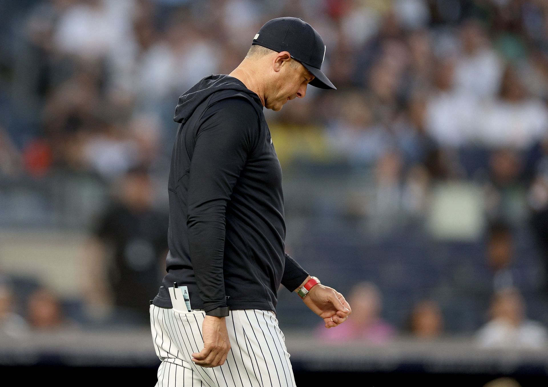 Aaron Boone puts on a Yankees cap and jersey after the New York Yankees  Introduce Aaron Boone as their new manager at Yankee Stadium in New York  City on December 6, 2017.