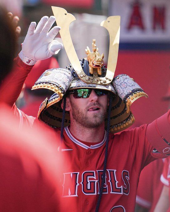 KANSAS CITY, MO - JUNE 18: Los Angeles Angels center fielder Mike Trout  (27) wears the team's Samurai Hat in the dugout after hitting a solo home  run during a MLB game