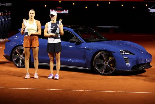 Aryna Sabalenka and Iga Swiatek posing with their respective trophies in Stuttgart