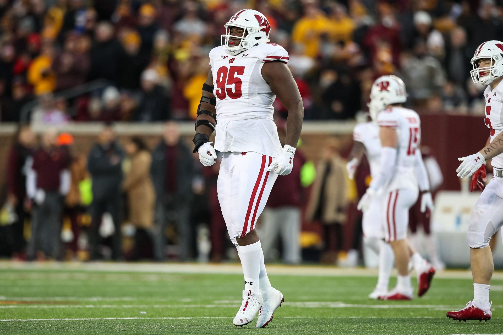 Keeanu Benton #95 of the Wisconsin Badgers celebrates after recording a sack against Tanner Morgan #2 of the Minnesota Golden Gophers