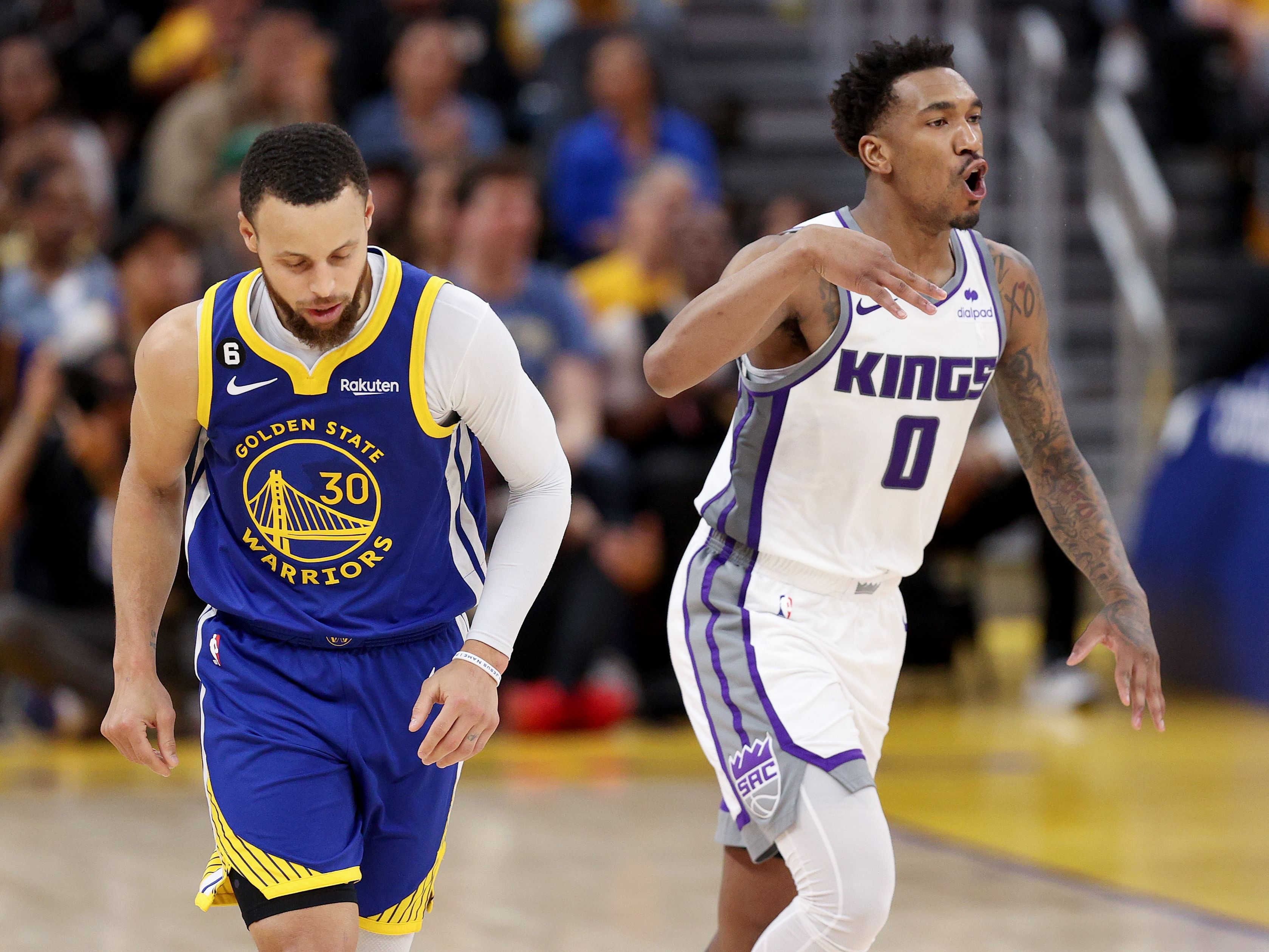 Steph Curry of the Golden State Warriors and Malik Monk of the Sacramento Kings