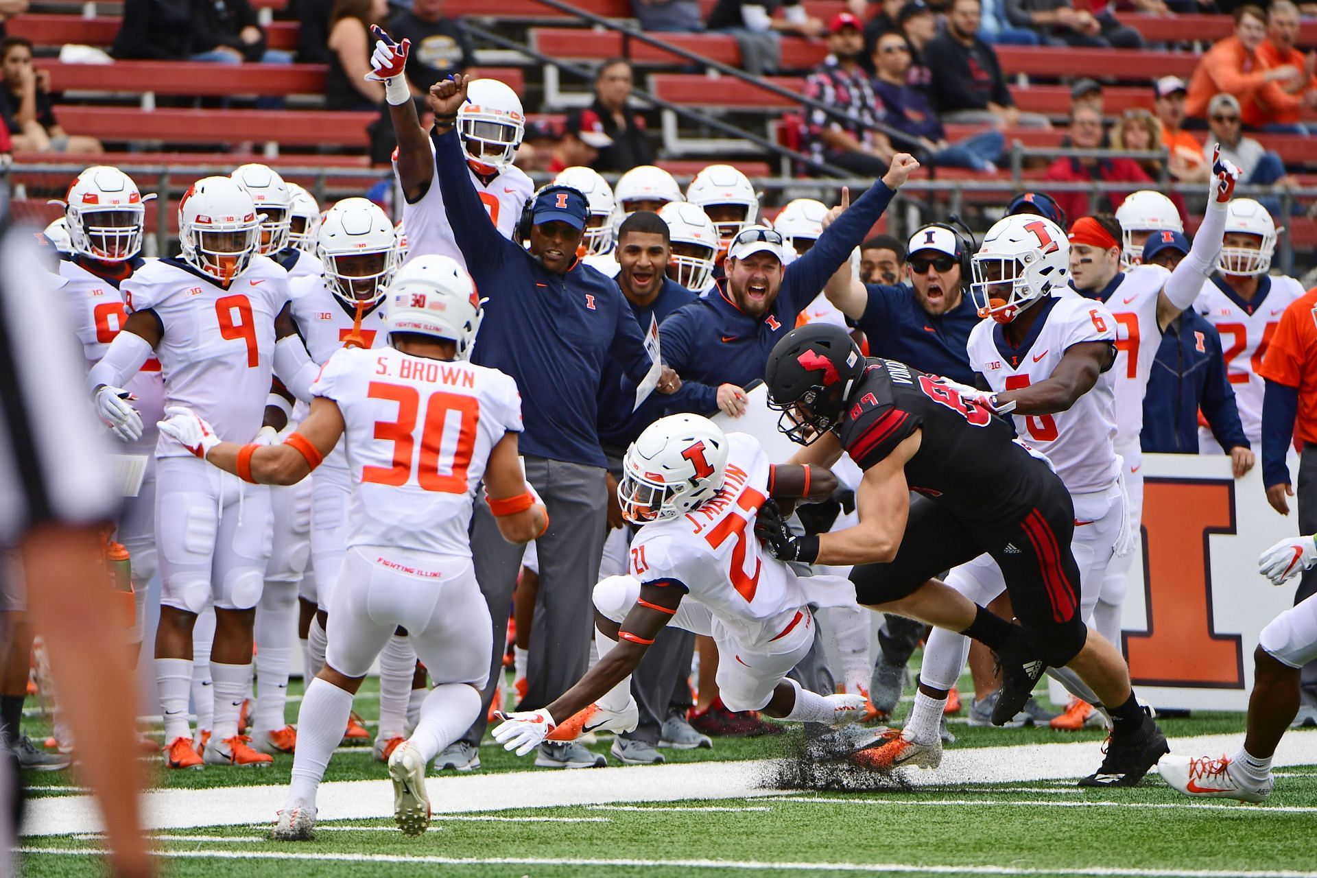  Jartavius Martin #21 of the Illinois Fighting Illini returns the ball after an interception against Travis Vokolek #89 of the Rutgers Scarlet Knights 