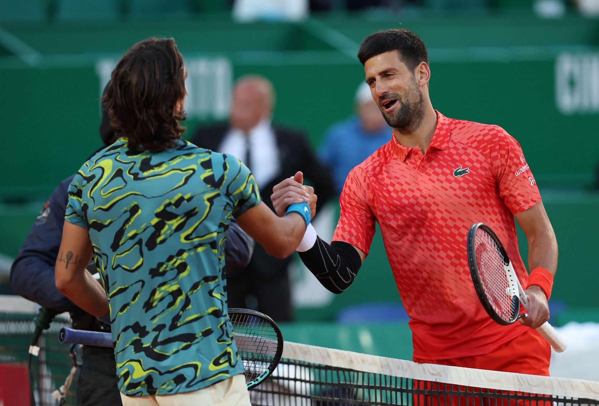 Lorenzo Musetti (L) and Novak Djokovic