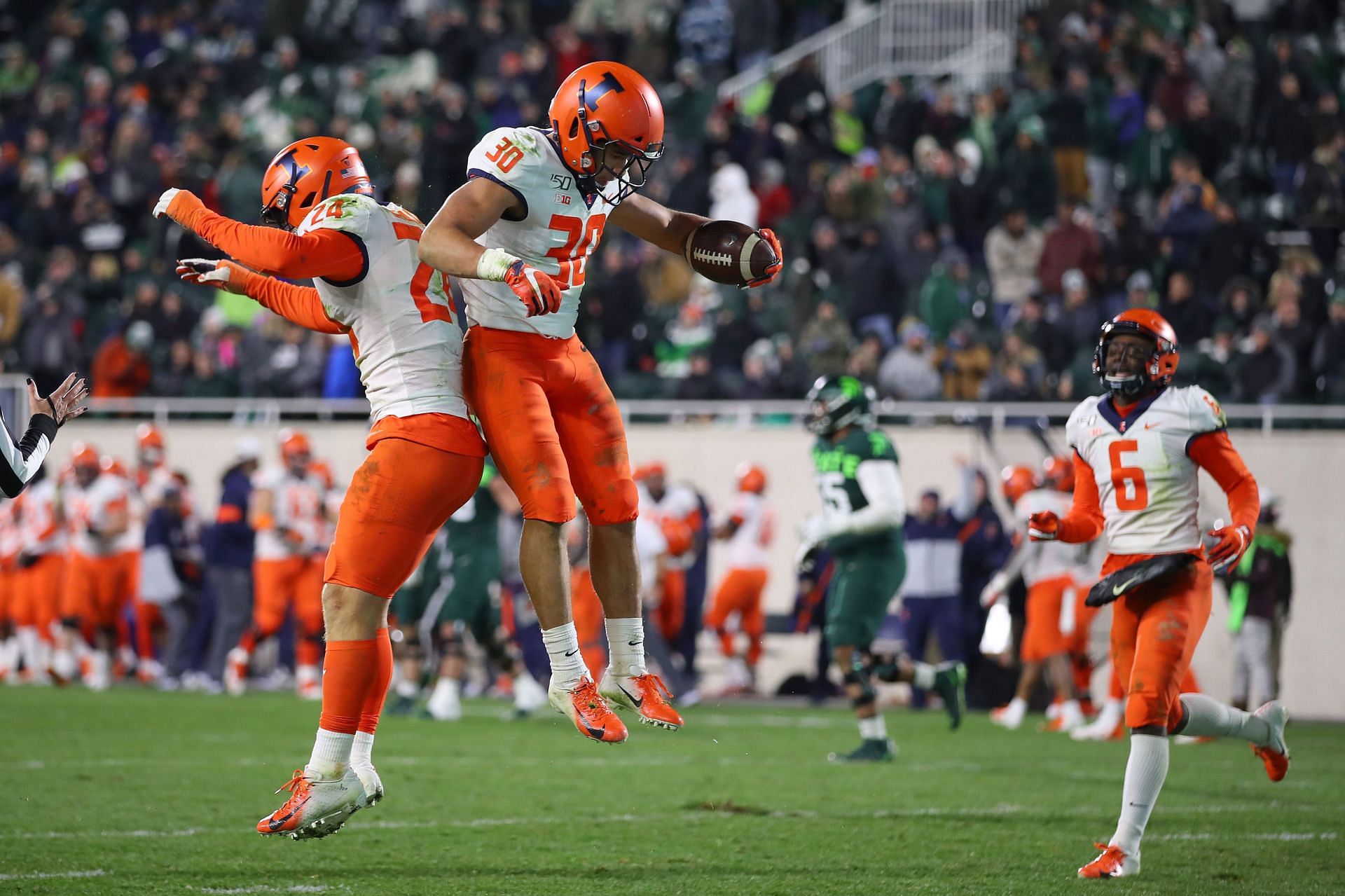 Sydney Brown #30 of the Illinois Fighting Illini celebrates his fourth quarter interception for a touchdown with Dawson DeGroot #24