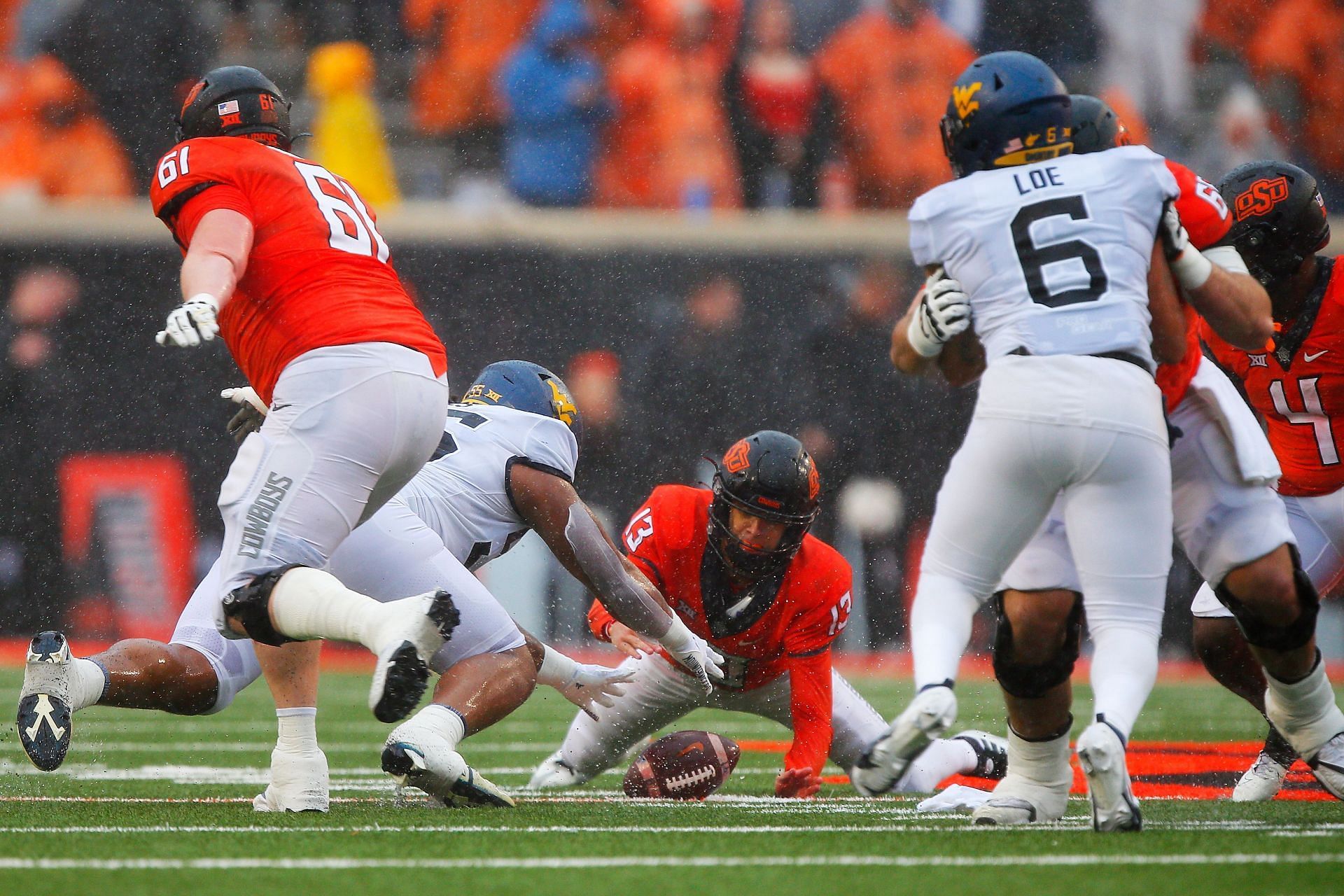 Defensive lineman Dante Stills #55 of the West Virginia Mountaineers dives on a fumble by quarterback Garret Rangel 