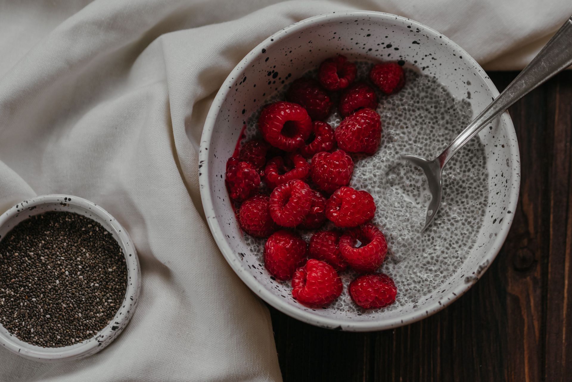 Chia pudding topped with fresh raspberries.  (Image via Pexels/ Polina Koalava)