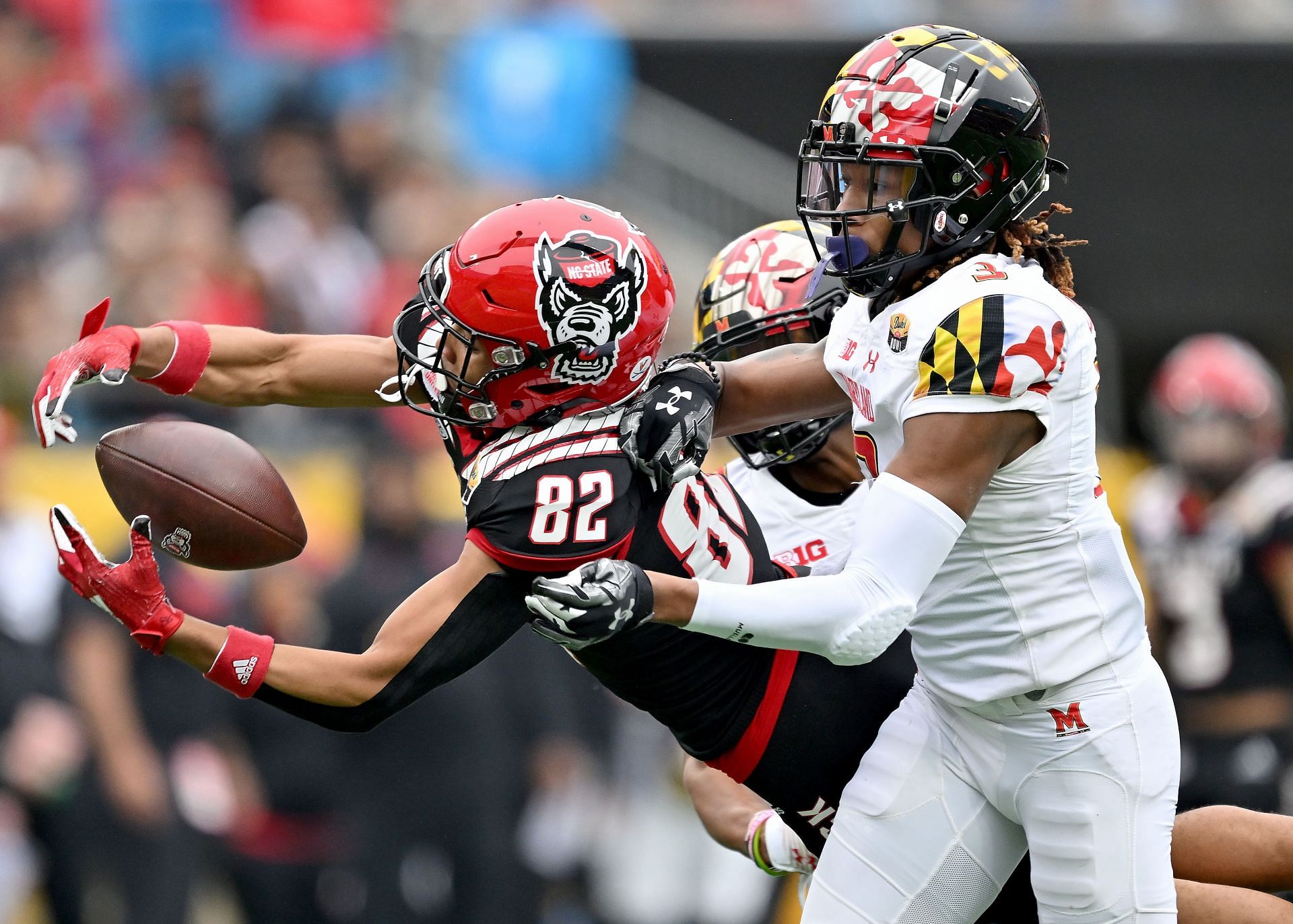 Deonte Banks #3 of the Maryland Terrapins defends a pass to Terrell Timmons Jr. #82 of the North Carolina State Wolfpack