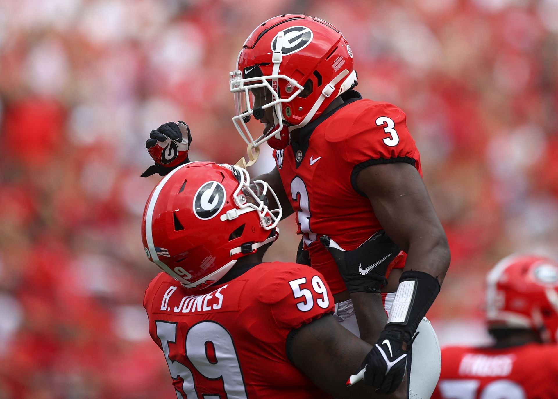 Zamir White #3 of the Georgia Bulldogs reacts with Broderick Jones #59 after a touchdown in the first half against the Arkansas Razorbacks