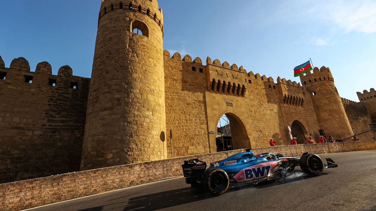 Fernando Alonso drives past the castle section of Baku City Street Circuit in 2022