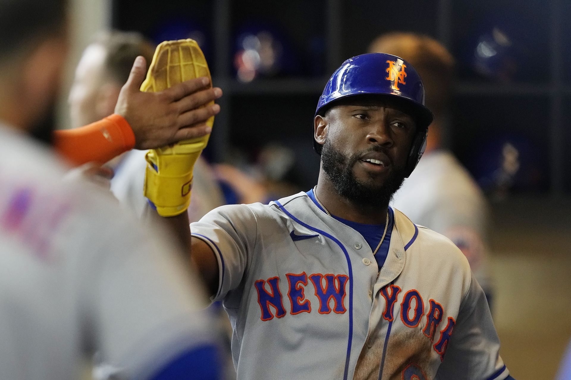Starling Marte of the New York Mets celebrates in the dugout after scoring a run.