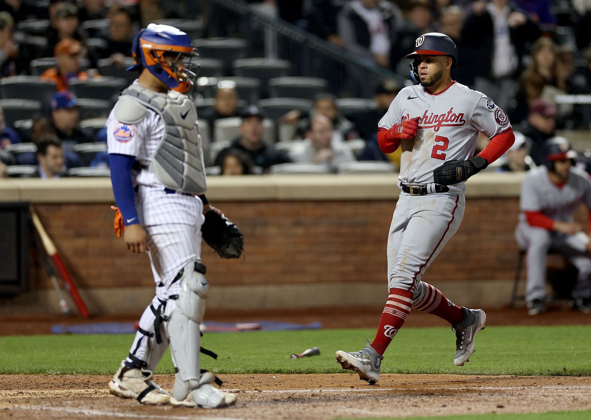 Luis Garcia #2 of the Washington Nationals scores in the sixth inning as Francisco Alvarez #4 of the New York Mets defends