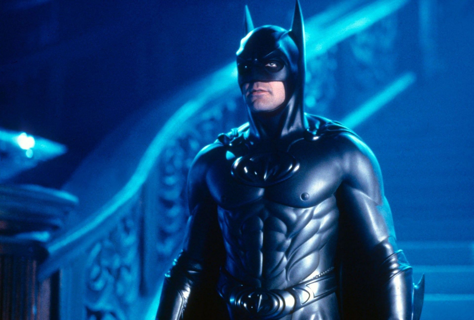 Batman in a ridiculous suit with overly defined muscles, bright colors, and nipple accents (Image via Warner Bros)