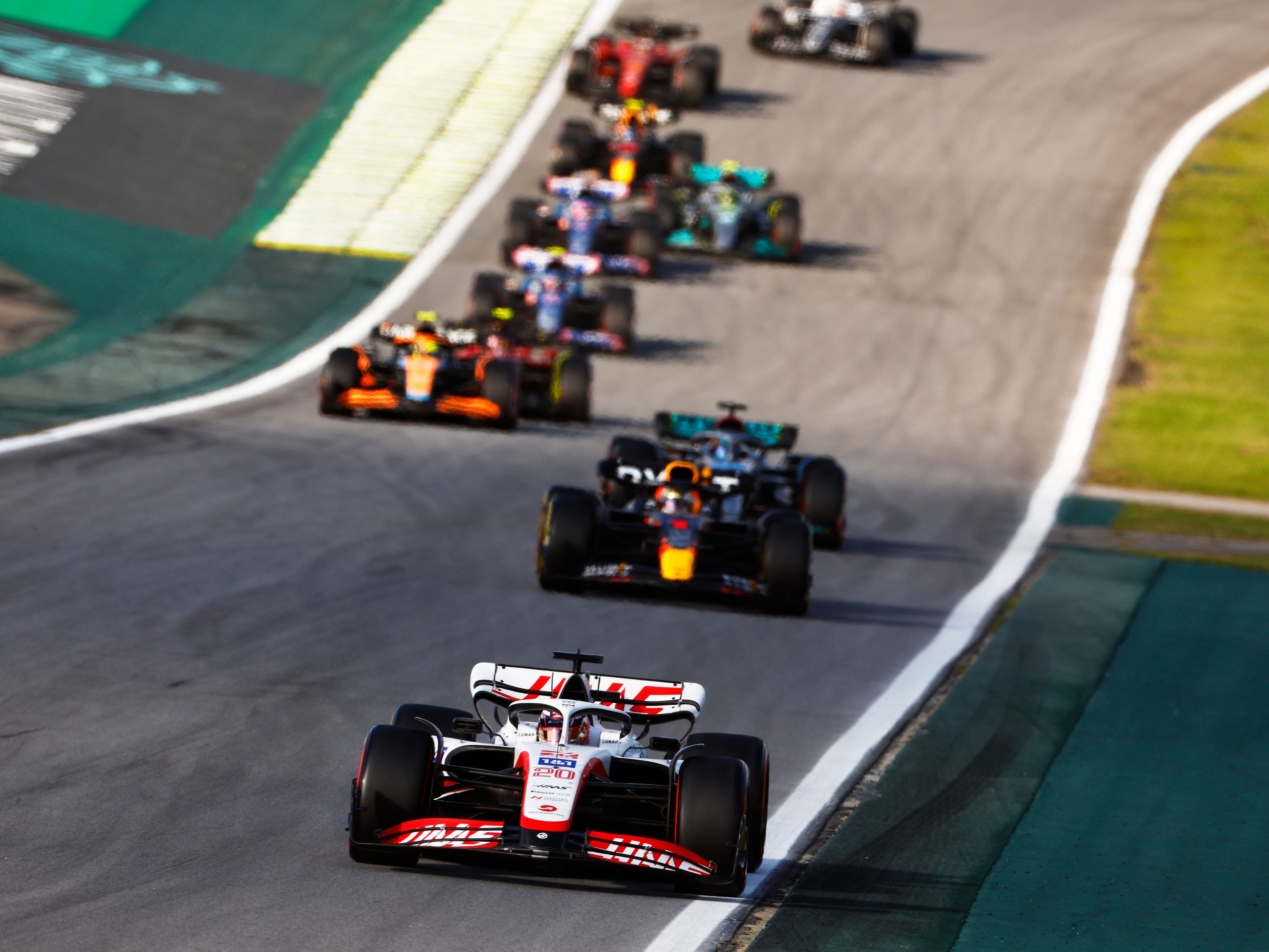 Kevin Magnussen (20) leads Max Verstappen (1) and the rest of the field at the start during the Sprint ahead of the 2022 F1 Brazilian Grand Prix (Photo by Chris Graythen/Getty Images)