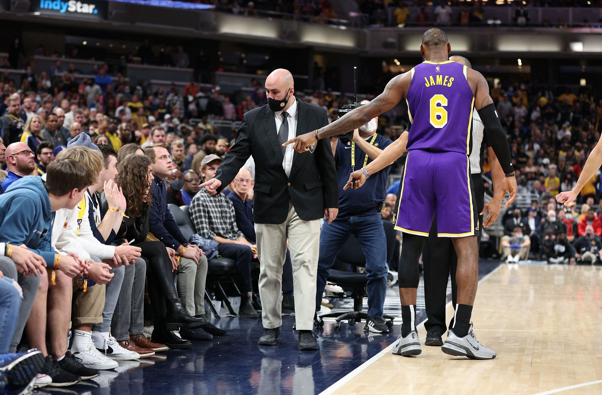 LeBron James pointing at a couple of NBA fans in a game against the Indiana Pacers