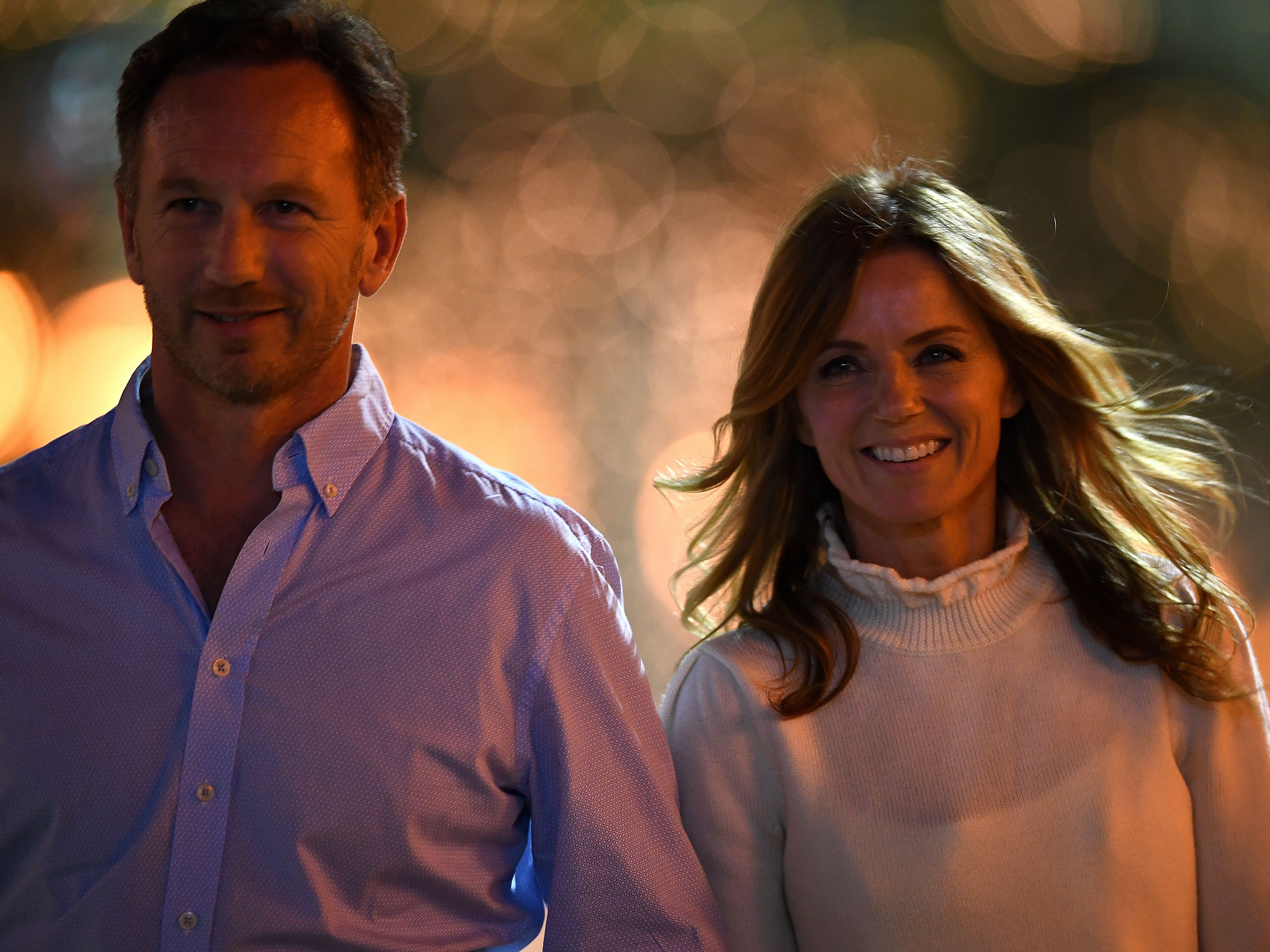 Red Bull Racing Team Principal Christian Horner and his wife Geri walk in the paddock after practice for the 2019 F1 Bahrain Grand Prix. (Photo by Clive Mason/Getty Images)