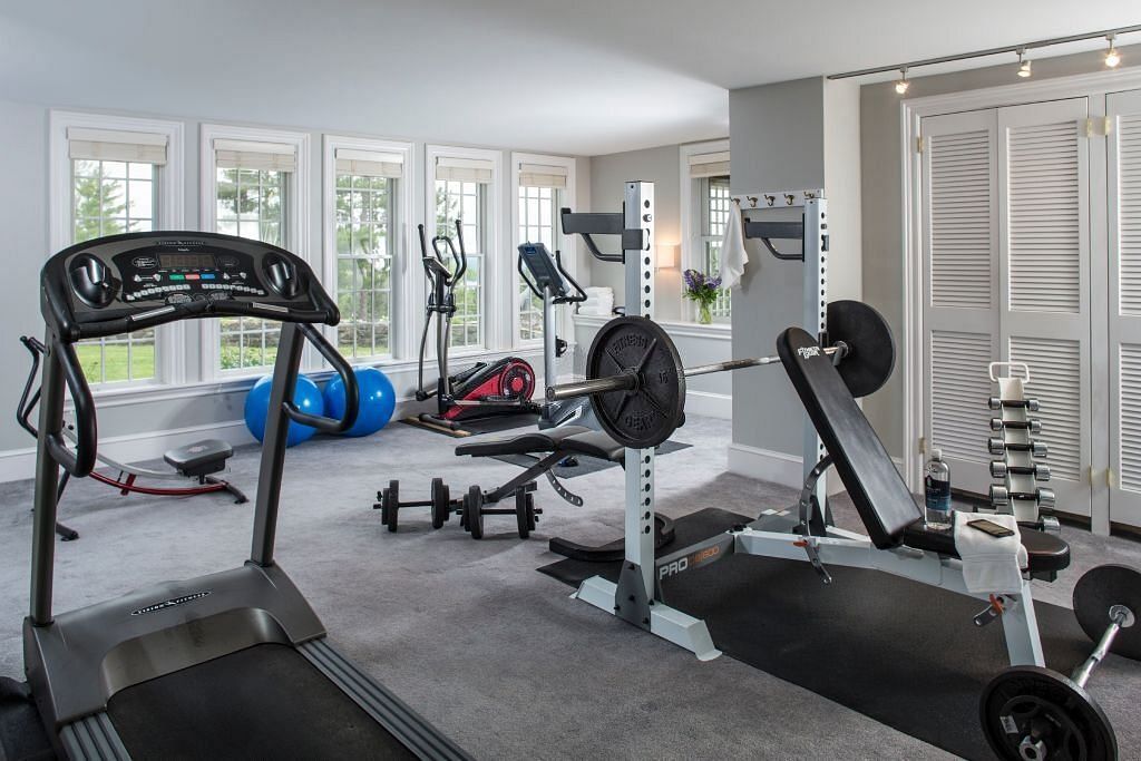 Home gym with treadmills weights and machines (Image via Getty Images)