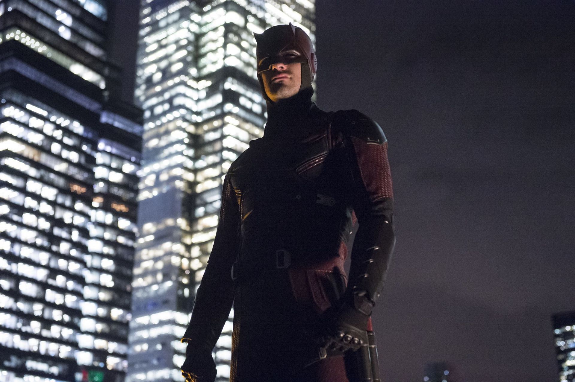 Charlie Cox as Matt Murdock, aka Daredevil, standing on a rooftop in his signature red suit (Image via Netflix)