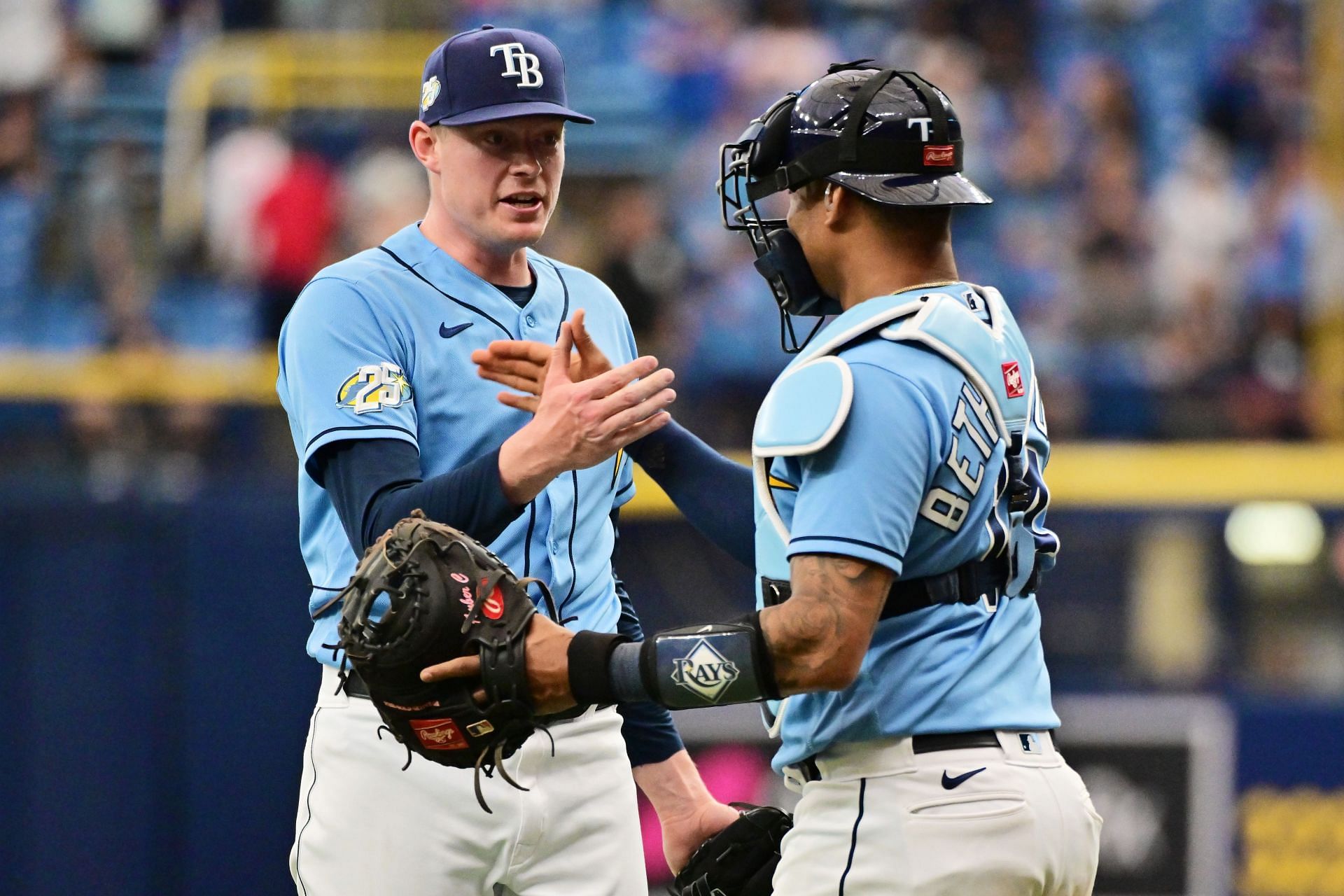 Pete Fairbanks #29 and Christian Bethancourt #14 celebrate after defeating the Chicago White Sox