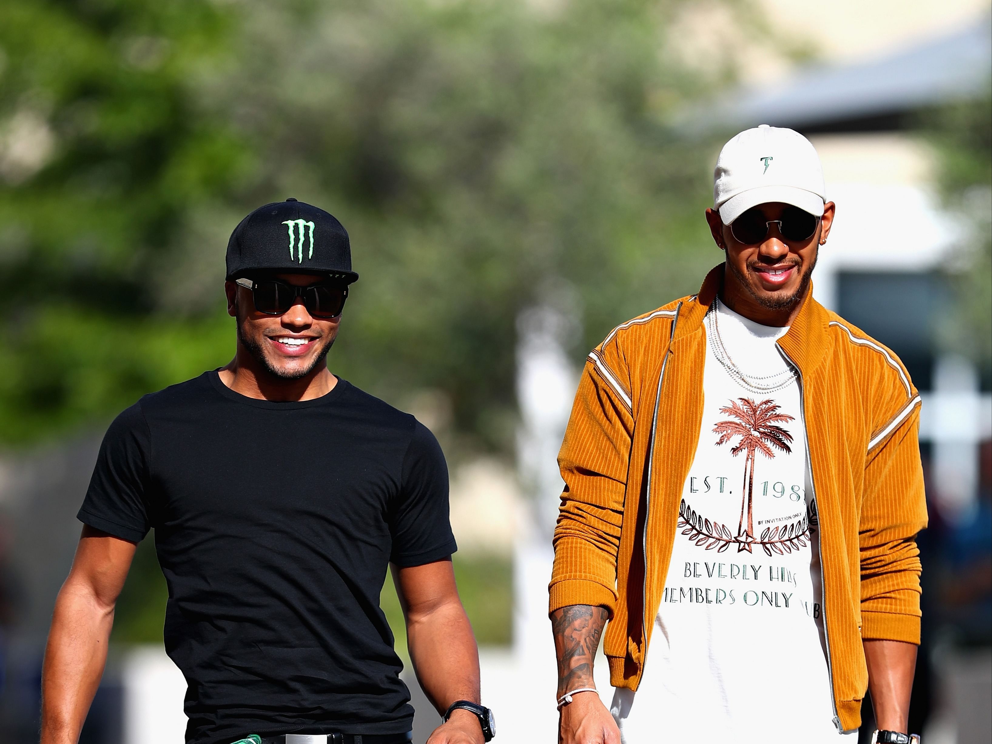 Lewis Hamilton walks in the paddock with his brother Nicholas Hamilton during previews ahead of the 2017 F1 United States Grand Prix. (Photo by Clive Rose/Getty Images)