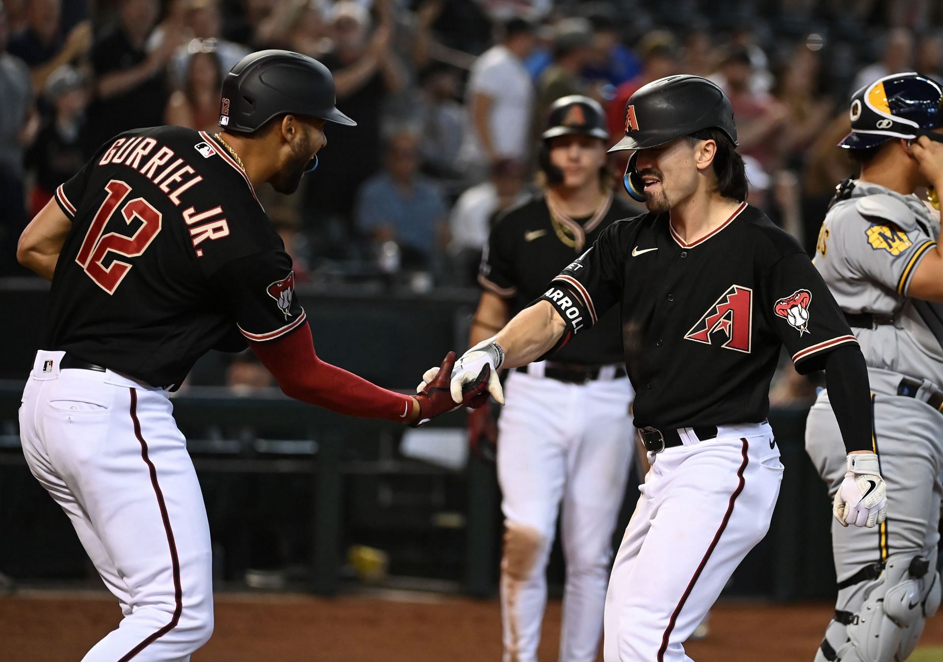 Corbin Caroll, right, celebrates with Lourdes Gurriel Jr after hitting a two-run home run.