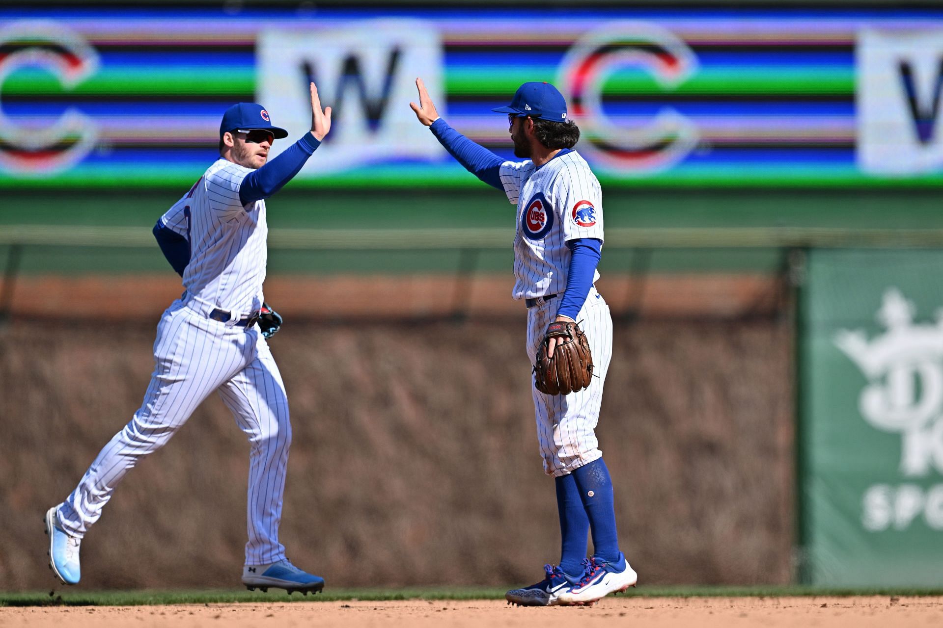 Ian Happ, left, and Dansby Swanson of the Chicago Cubs celebrate after defeating the Texas Rangers 2-0.