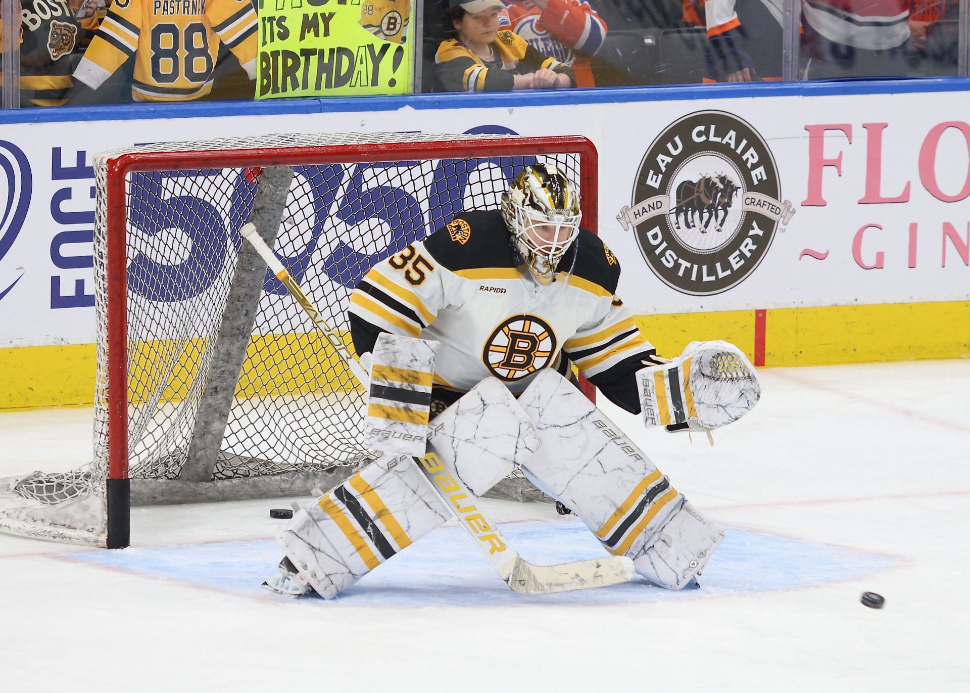 Boston Bruins goaltender Linus Ullmark, left, makes a stop of a